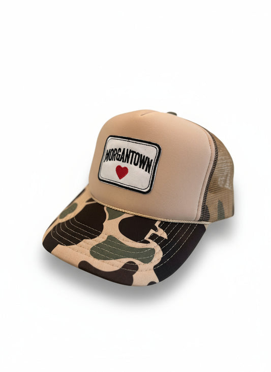 Camo trucker with 'Morgantown' patch held by a hand against a plain background